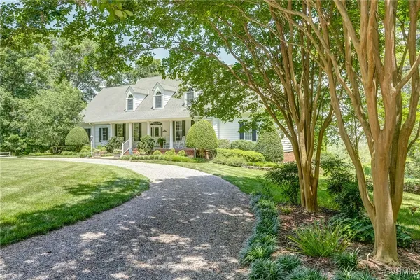 a front view of a house with yard and green space