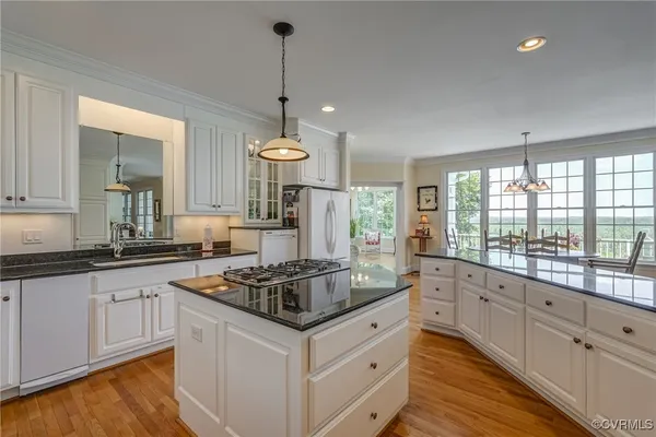 a kitchen with granite countertop a stove and a sink