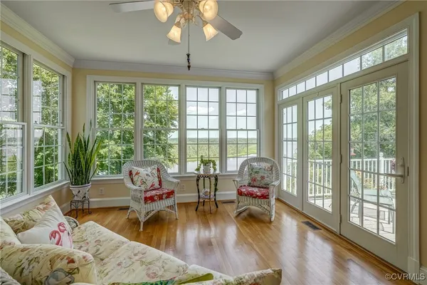 a living room with furniture and floor to ceiling windows