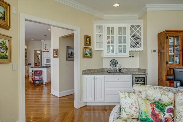 a view of kitchen center island wooden floor and stainless steel appliances