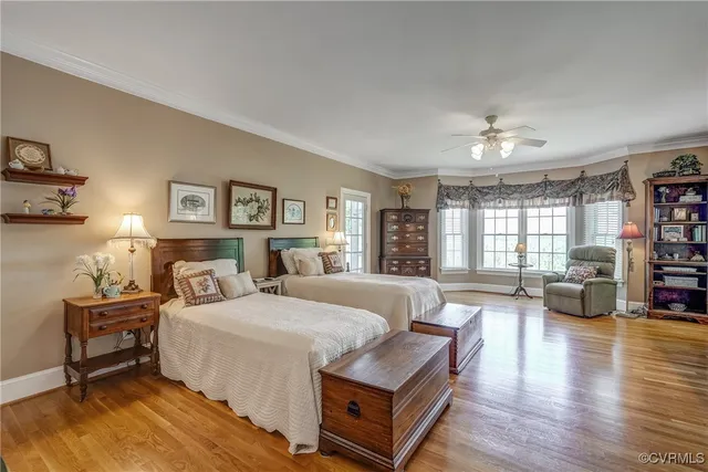 a bedroom with a bed couch and a large window