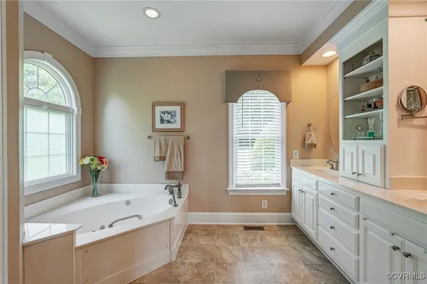 a spacious bathroom with a granite countertop tub mirror and a sink