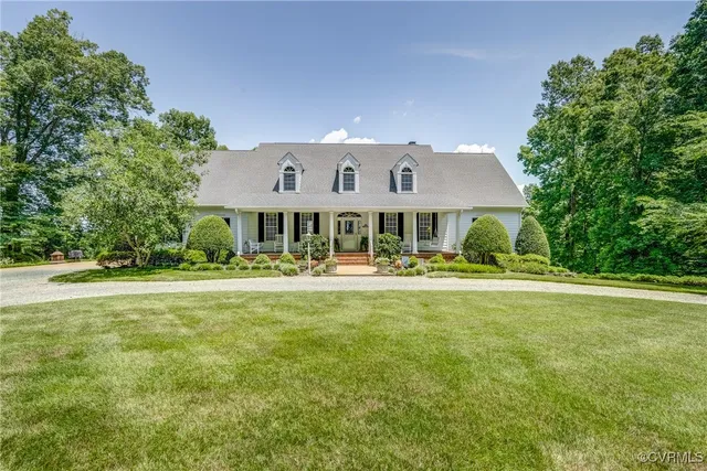 a front view of a house with swimming pool having outdoor seating