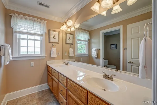 a bathroom with a sink double vanity and a mirror