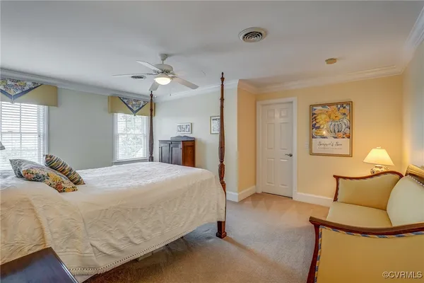 a bedroom with a bed and dresser with mirror