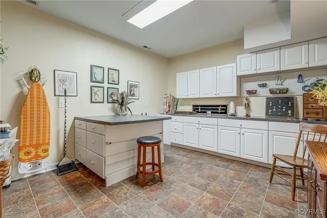 a living room with furniture a dining table and a chandelier
