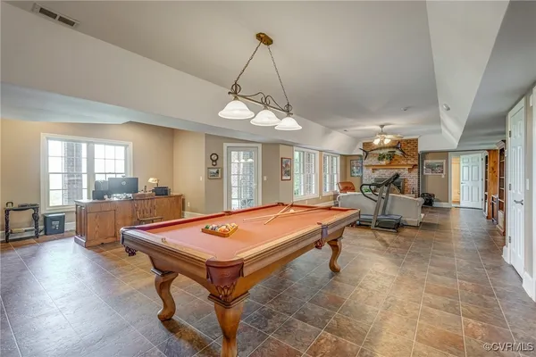 a living room with pool table and a table