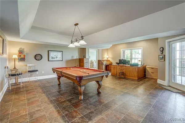 a living room with furniture a dining table and a chandelier
