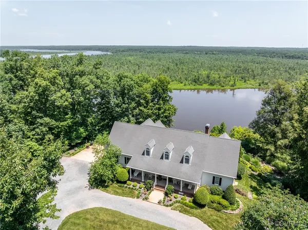an aerial view of house with yard and ocean view