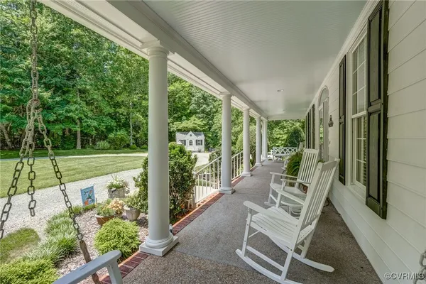a view of a chair and tables in the balcony