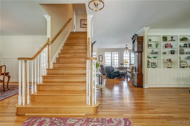 a view of entryway and hall with wooden floor