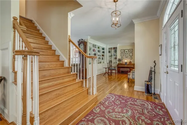 a view of a hallway view with wooden floor and staircase