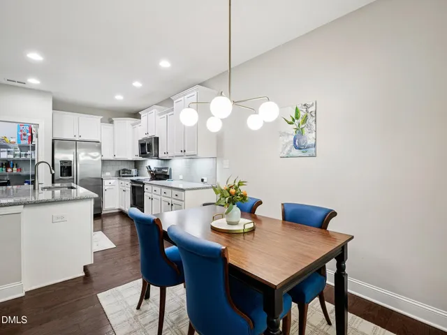 a living room with furniture a fireplace and a large window