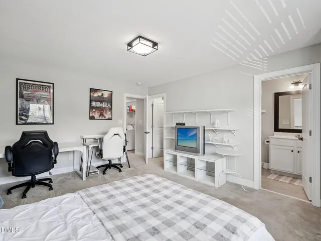 a bedroom with a bed and large window