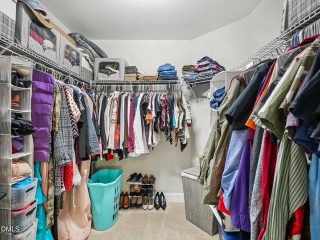 a bedroom with a bed and a chair