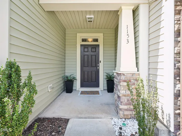 a view of a white house with large windows