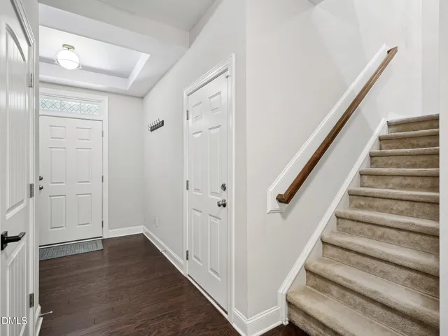 a front view of a house with a potted plant