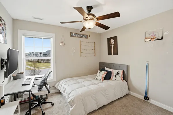 a bedroom with a bed and a desk