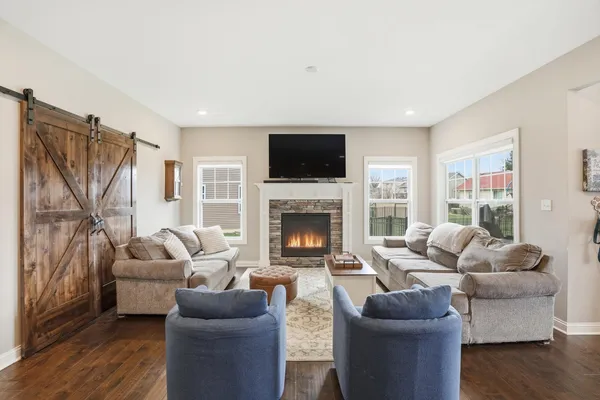 a living room with furniture flat screen tv and a fireplace