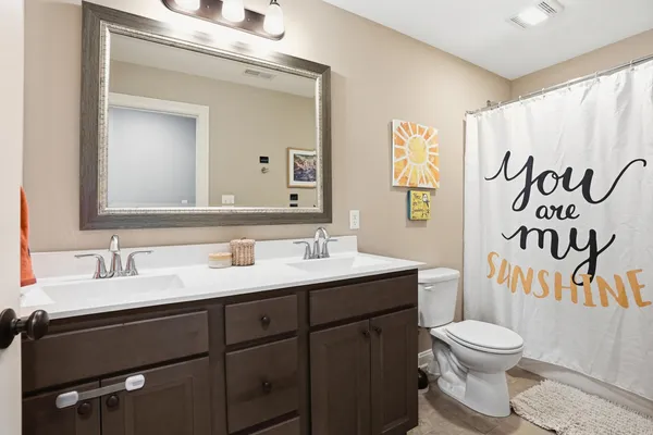 a bathroom with a toilet a sink and a mirror