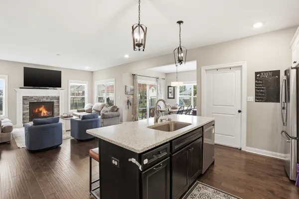 a kitchen with sink stove and refrigerator
