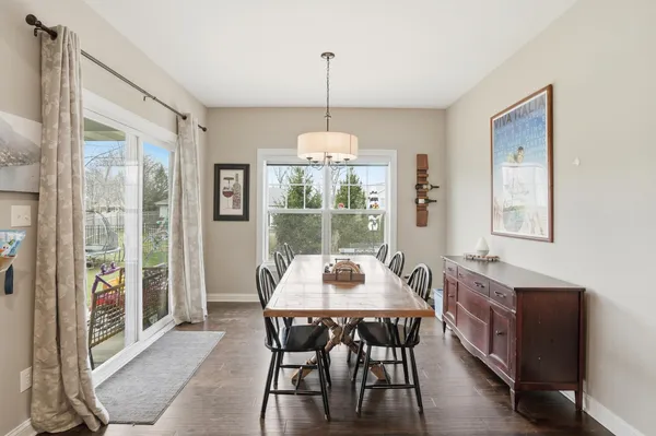 a dining room with furniture window and chandelier