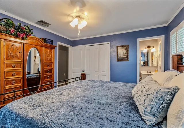 a spacious bedroom with a bed and a dresser