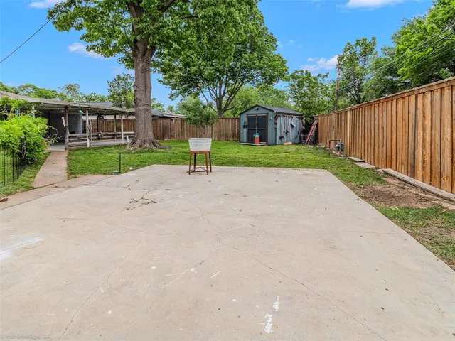 a view of a house with a yard and palm trees