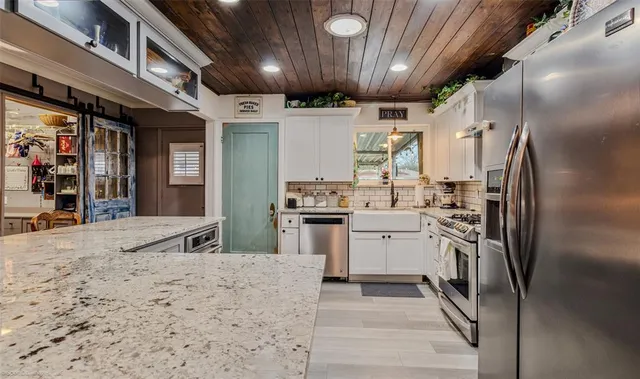a kitchen with refrigerator and cabinets