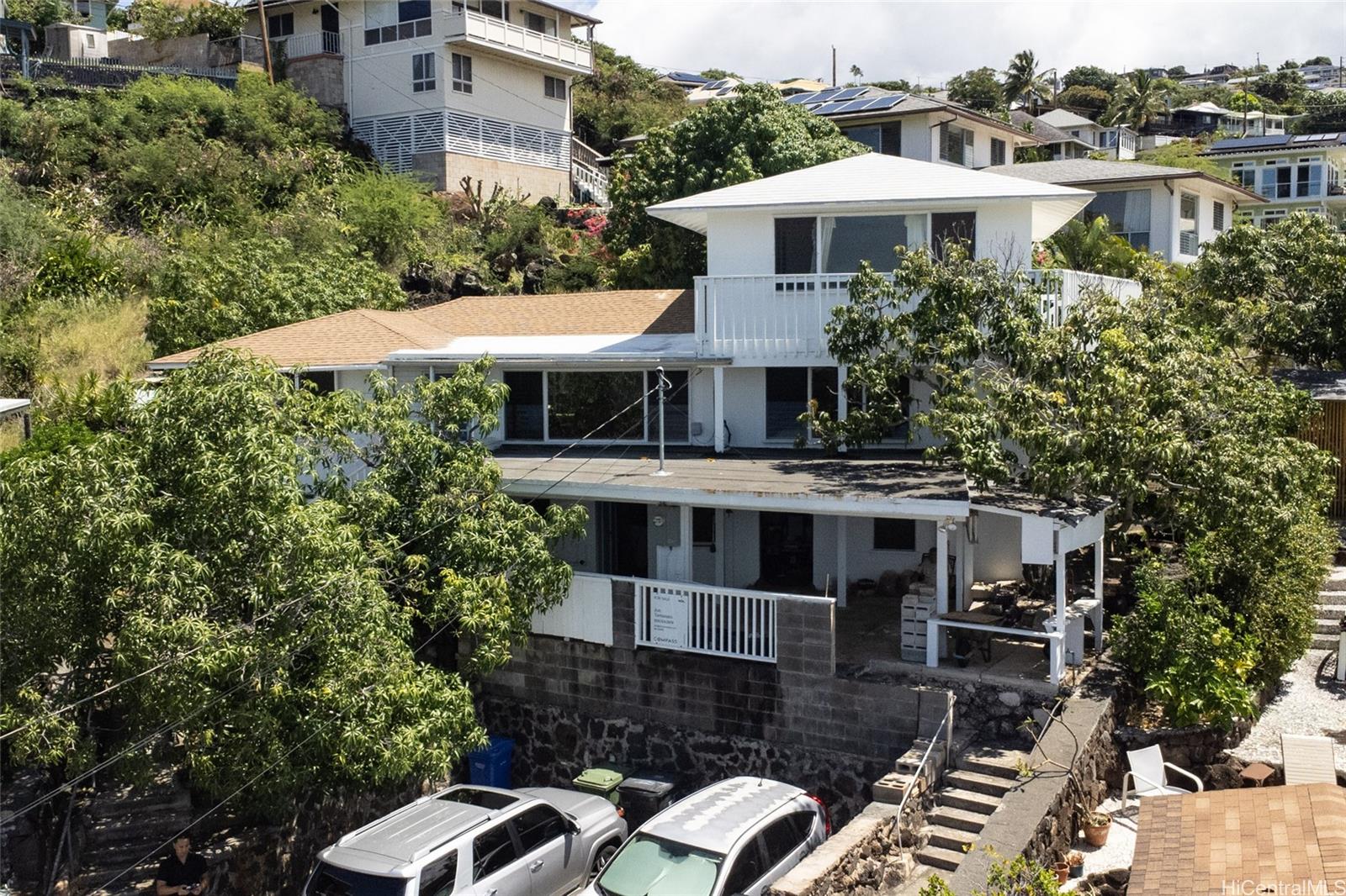 a front view of a house with a yard and balcony