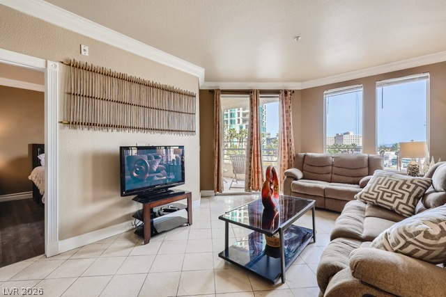 270 East Flamingo Road, Unit 315 Las Vegas, NV 89169 - Photo 3 of 11 Natural light floods this inviting living space, connecting to a private balcony and offering a peek into an adjacent bedroom.