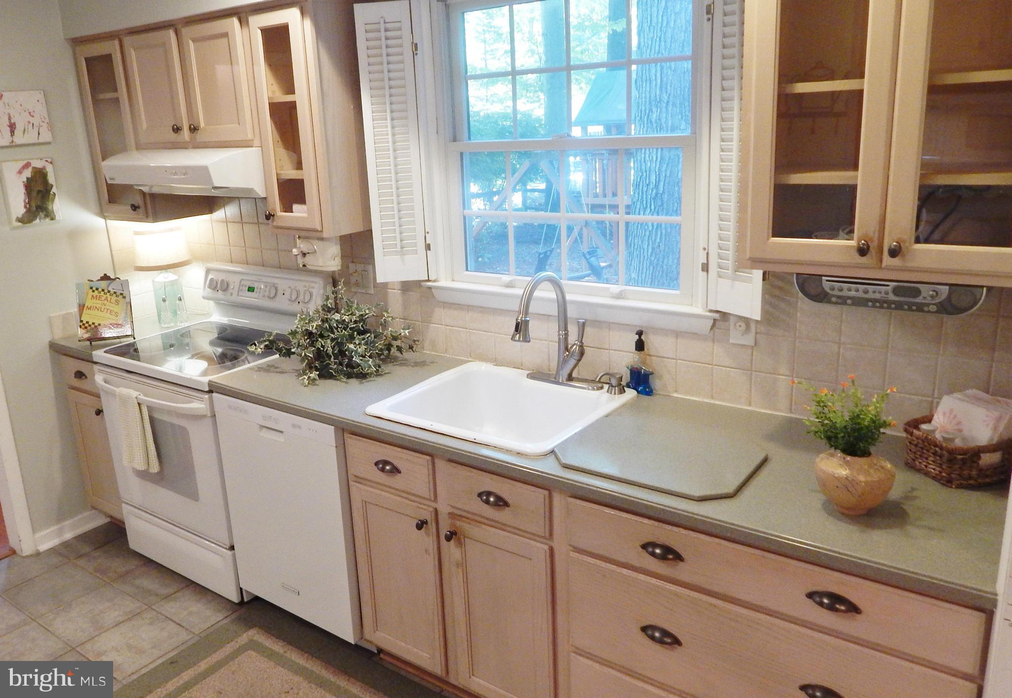 6032 Stevens Forest Road Columbia, MD 21045 - Photo 11 of 29 a kitchen with white cabinets and window