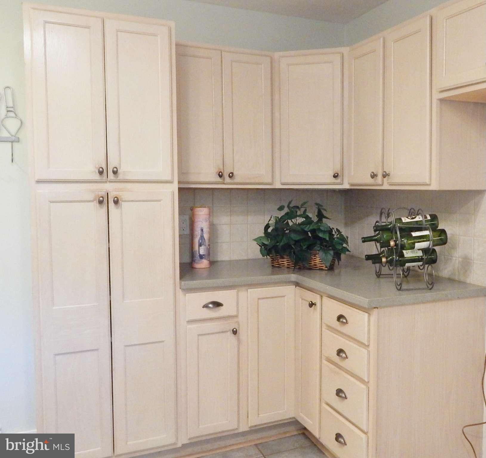6032 Stevens Forest Road Columbia, MD 21045 - Photo 12 of 29 a kitchen with white cabinets and white appliances