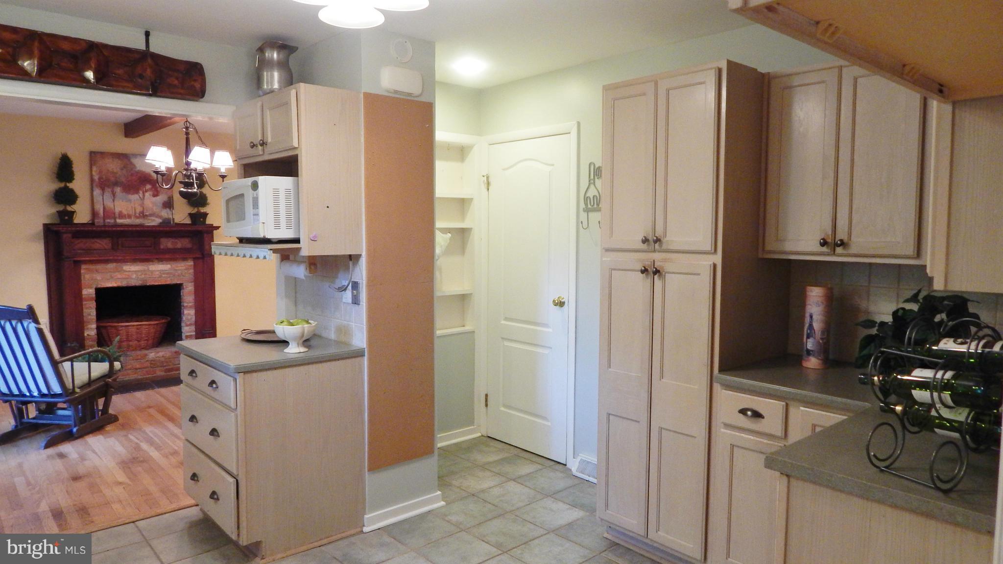 6032 Stevens Forest Road Columbia, MD 21045 - Photo 14 of 29 a room with stainless steel appliances kitchen island granite countertop a refrigerator and a stove top oven