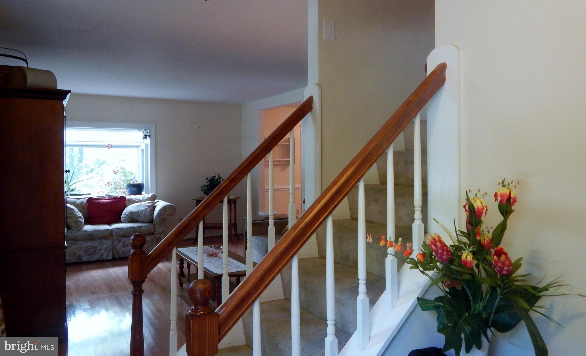 6032 Stevens Forest Road Columbia, MD 21045 - Photo 3 of 29 a view of entryway with wooden floor and stairs