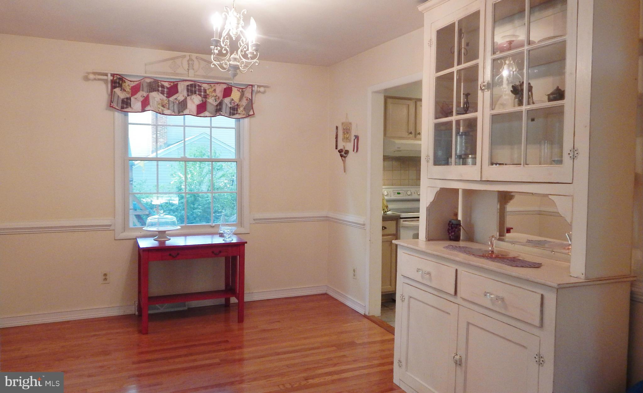 6032 Stevens Forest Road Columbia, MD 21045 - Photo 8 of 29 a view of a dining room with furniture window and wooden floor