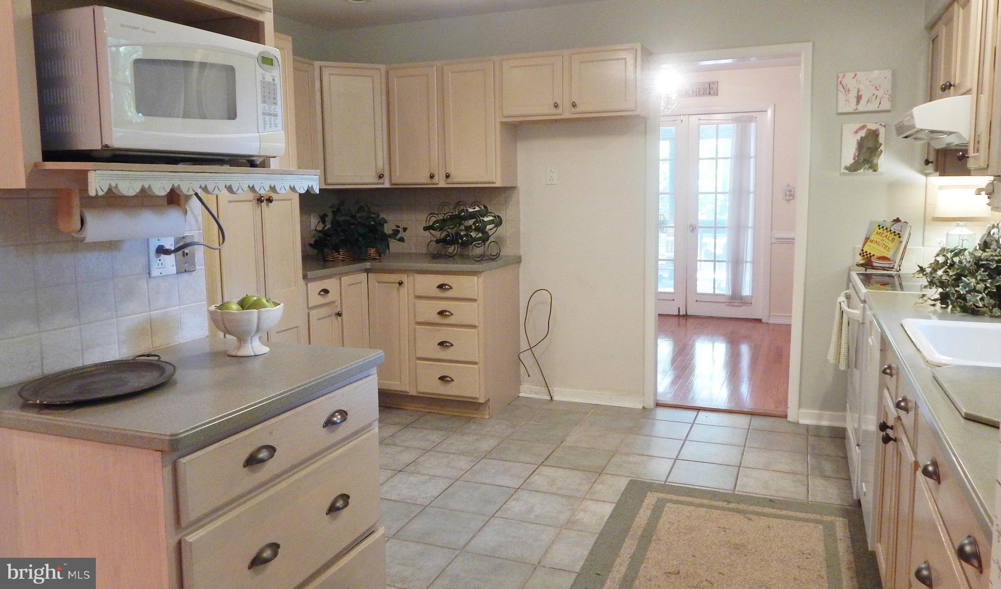 6032 Stevens Forest Road Columbia, MD 21045 - Photo 10 of 29 a kitchen with stainless steel appliances a cabinets and a stove top oven