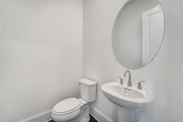 a bathroom with a sink a mirror and a toilet