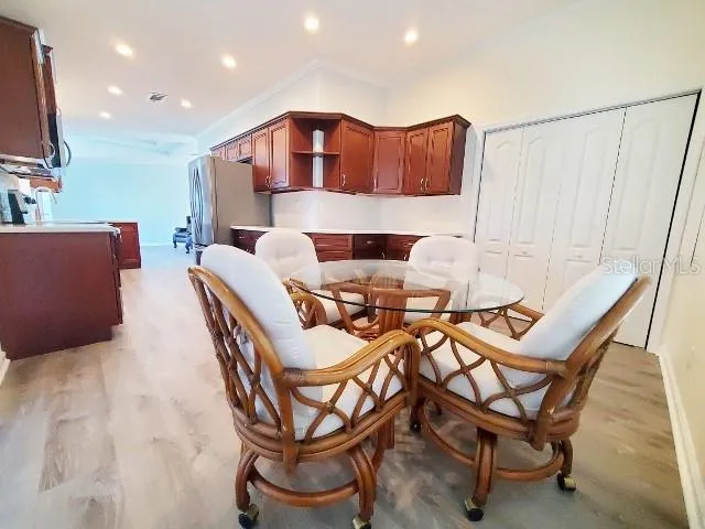 a view of a dining room with furniture and a flat screen tv