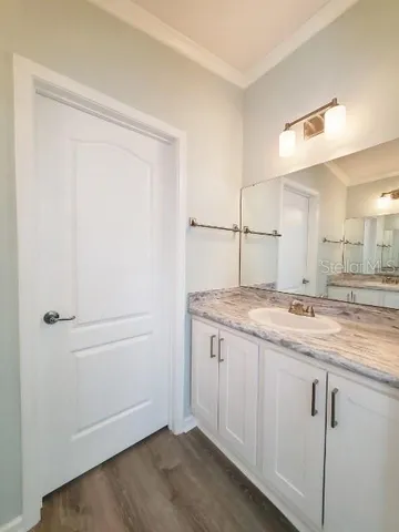 a bathroom with a granite countertop sink and mirror