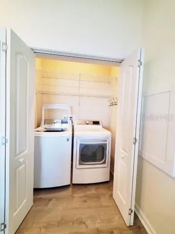 a utility room with sink dryer and washer