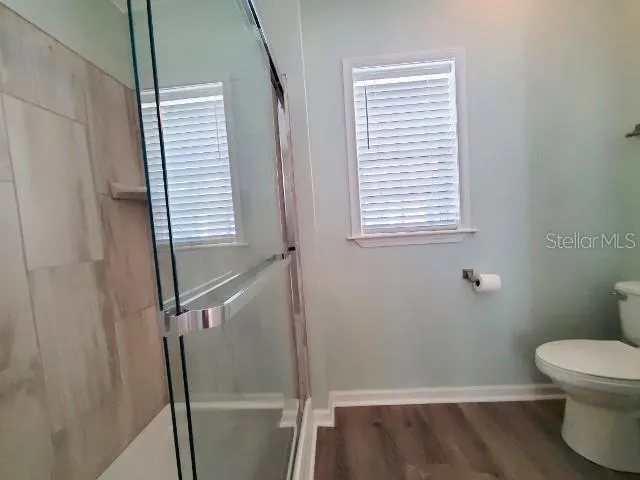 a bathroom with a toilet and a window