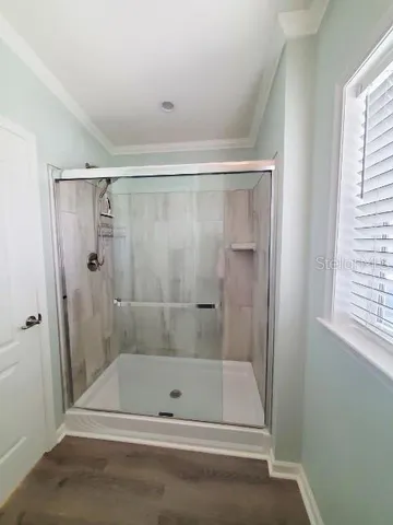 a bathroom with a shower and a bath tub