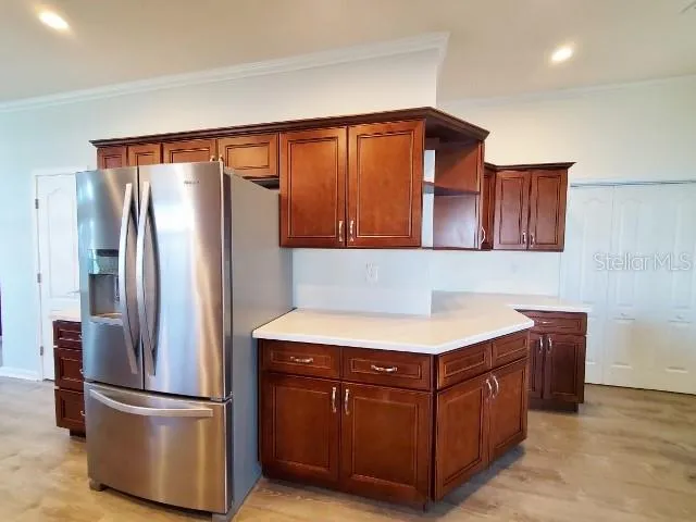 a kitchen with stainless steel appliances granite countertop a refrigerator and a cabinets