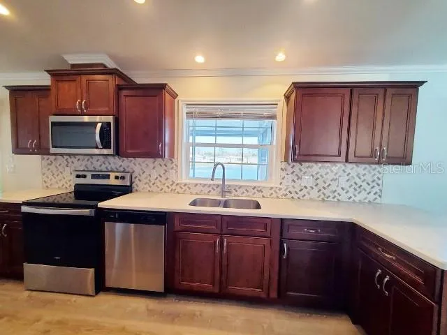 a kitchen with a sink stove top oven and cabinets
