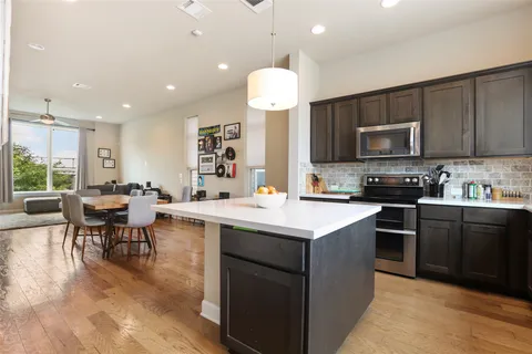 a kitchen with a sink stove and microwave