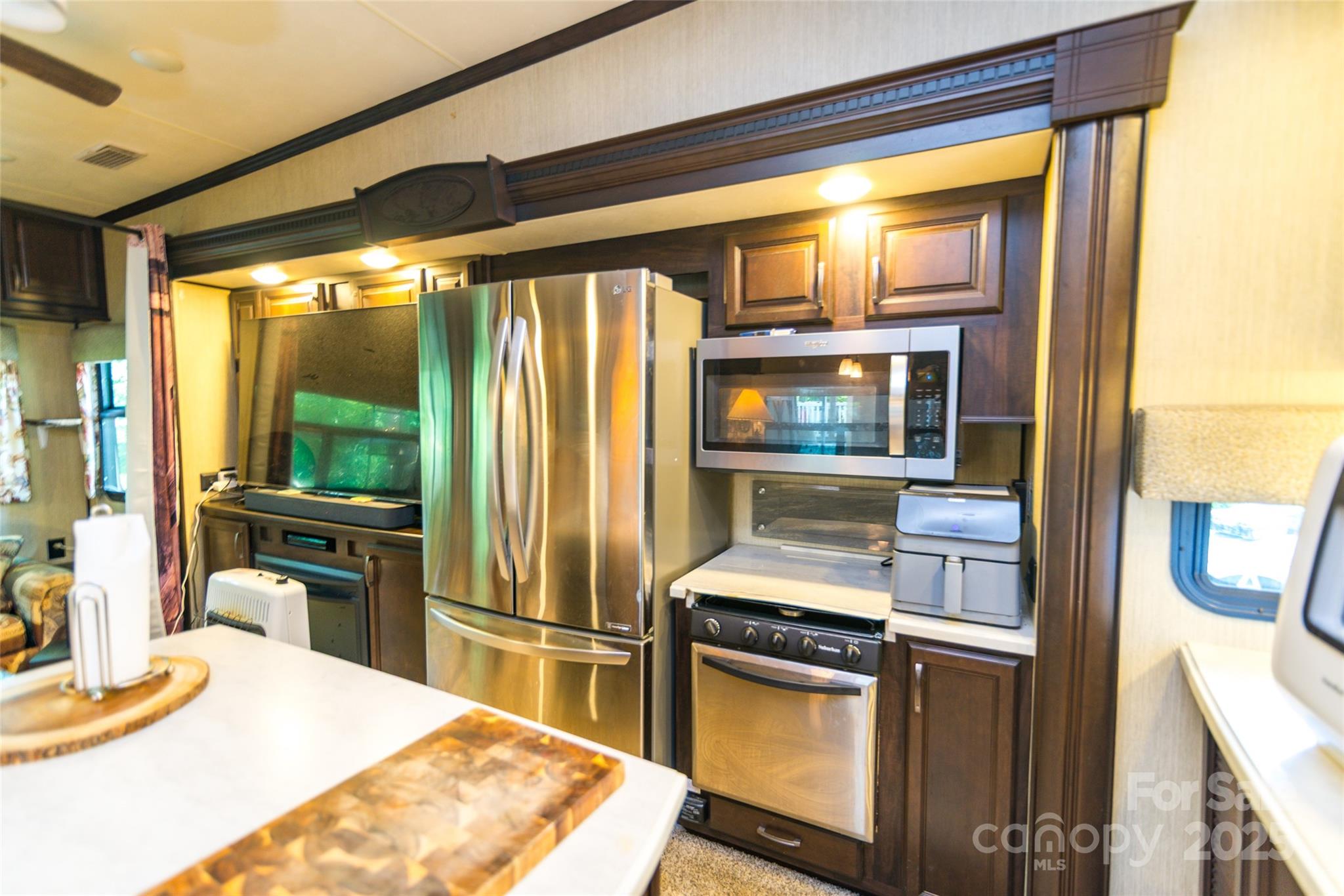 217 Mallard Loop Waynesville, NC 28785 - Photo 7 of 11 a kitchen with a refrigerator and a stove