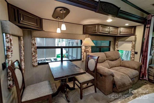 a living room with furniture a window and a chandelier