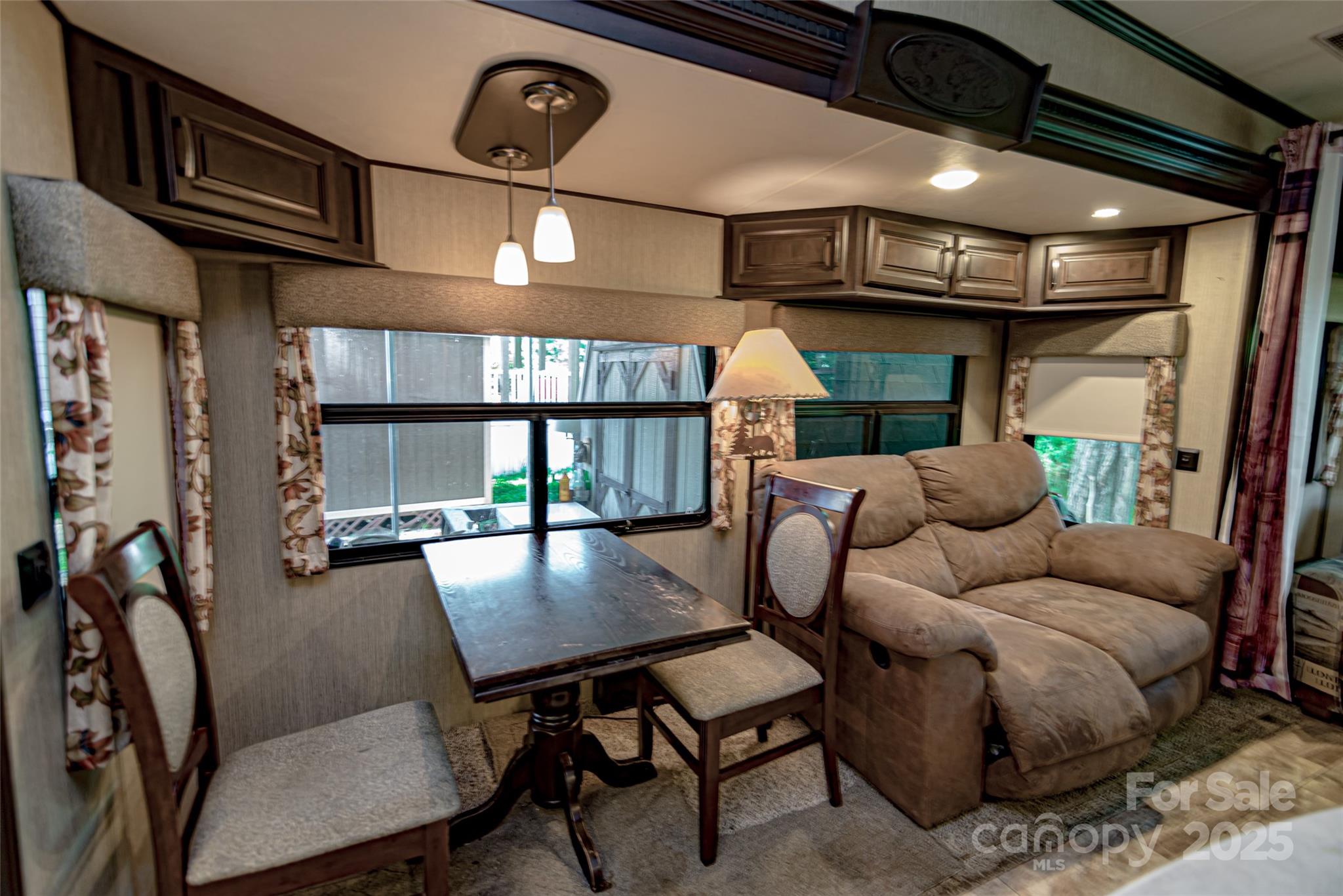 217 Mallard Loop Waynesville, NC 28785 - Photo 9 of 11 a living room with furniture a window and a chandelier