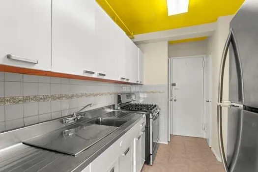 a kitchen with stainless steel appliances a sink and a refrigerator